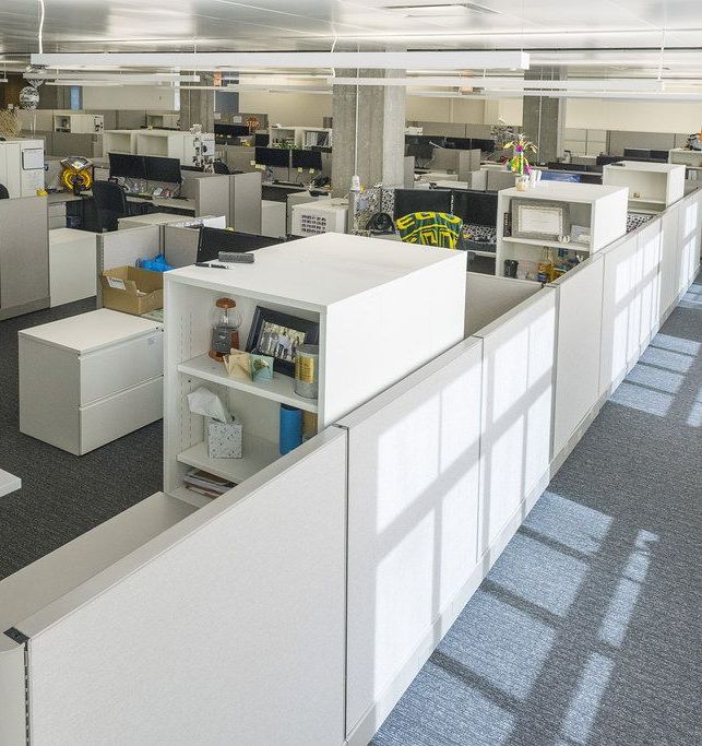 An open office floor of cubicles, empty and in order